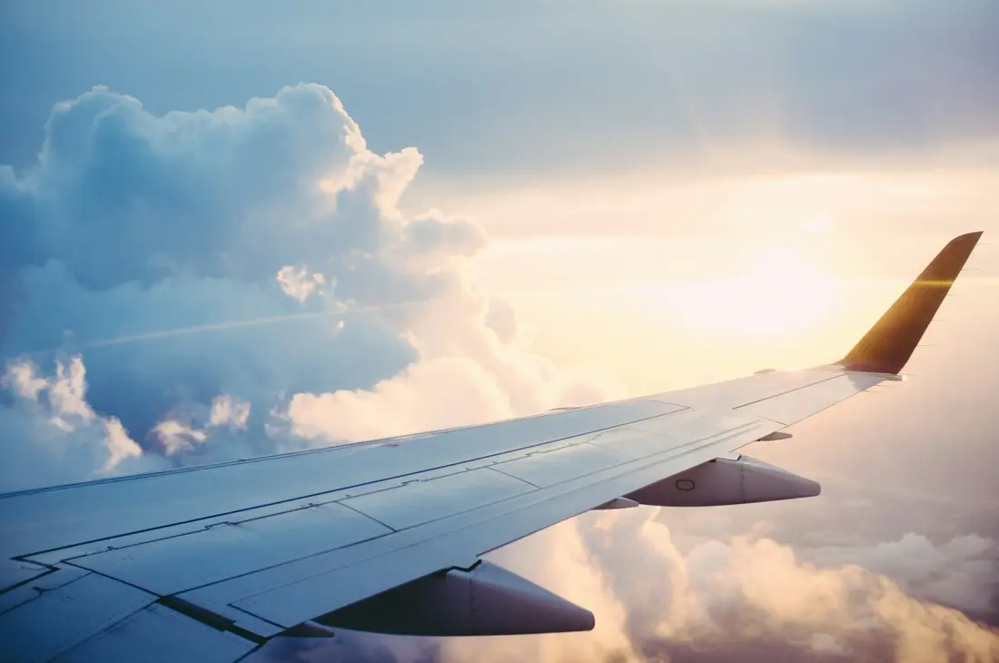 Airplane wing against a blue sky